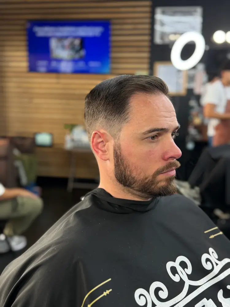 Classic side part with taper and full beard